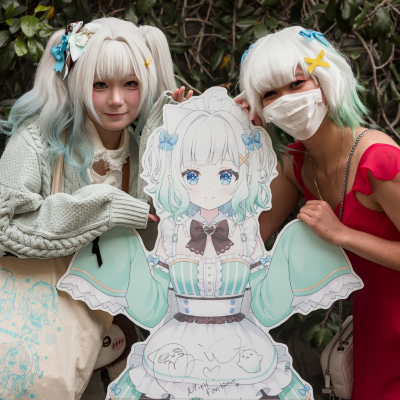 Two Mint cosplayers pose for a photo outside of the Peppermint Club